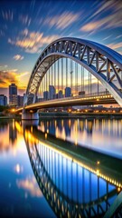 Obraz premium Modern steel arch bridge at dusk