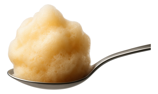 A spoon carrying a frothy cloud of ginger foam, ethereal and soft.