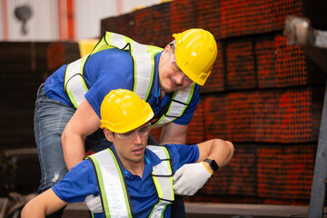 Industrial safety scenario showing emergency assistance during workplace accident, emphasizing...