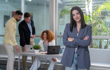 Confident businesswoman leading diverse team in modern office