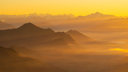 Golden Hour Sunrise Over Misty Mountain Ranges: Serene Landscape Photography