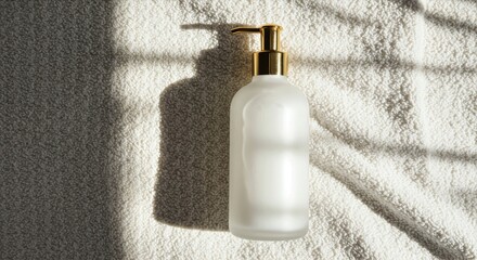 Soft daylight illuminates a lotion bottle with gold pump on a knitted towel surrounded by subtle shadows and neutral tones