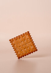 Square whole grain cookies on beige background, copy space