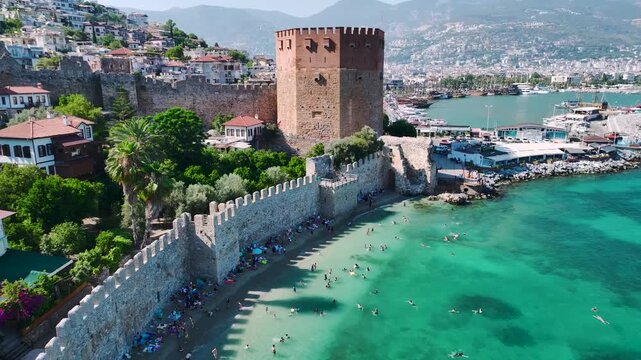 People enjoying the Alanya Red Tower and the sea