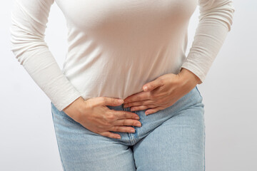 Lower Abdominal Pain in Females. Woman suffering from spasms and pain clutching her body. Women's...