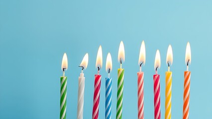 Colorful birthday candles with glowing flames, creating a festive and celebratory atmosphere.