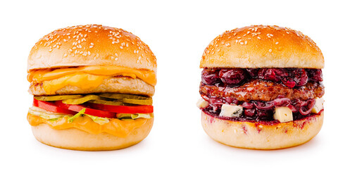 Two tasty burgers with cheese and fruit on sesame seed buns