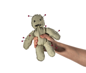 Homemade voodoo doll on isolated background. Hand squeezing toy for halloween ritual, spells, revenge