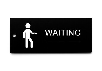 A black sign with a white figure looking at their watch and the word waiting displayed on the right