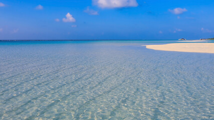 Summer lagoon Ripples in the sand at low tide on a beach with sandbar and blue sea in Maldives island