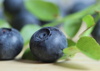 Closeup of bilberry on wooden background.