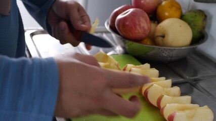 Asian muslim woman cutting slicing apple and pear fruits in kitchen - Powered by Adobe
