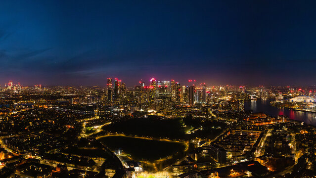 A breathtaking view showcasing London's illuminated skyline at night, highlighting the vibrant city and its iconic buildings along the river.