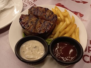 Delicious beef steak with vegetables, potatoes and sauces as a compliment