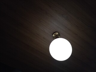 A lamp that lights up in the darkness, becomes a symbol of a figure that illuminates the...