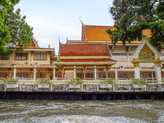 Fototapeta premium Temple on the Khlong Canal Phra Khanong. These house on the river in BKK are usually made from timber in Bangkok Thailand