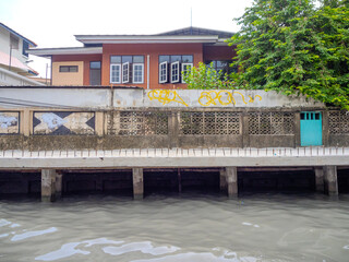 Old historical residential house in Phra Khanong on the Khlong a Canal system in BKK used by commuters taking a long tail Boat Ferry system to avoid traffic congestion Bangkok Thailand