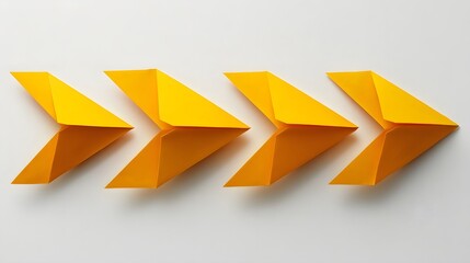 Four yellow origami arrows pointing rightward