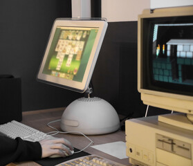 Vintage Computer monitor Display. desktop computer  museum. one boy playing cards