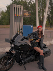 Confident Woman with Helmet near Motorcycle