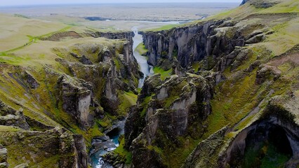 Fjadrárgljúfur is a beautiful canyon in southeast Iceland. The Fjadrá river flows through it. The canyon has steep walls and winding water. 