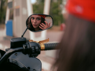Biker Woman Reflection in Motorcycle Mirror