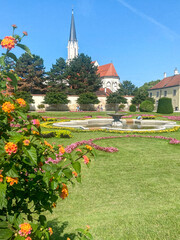 Beautiful garden with flowers and church tower in the background