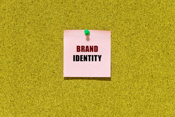 Brand identity text on post-it paper on a bulletin cork boad 