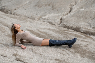 Full body portrait of a young beautiful woman in beige dress