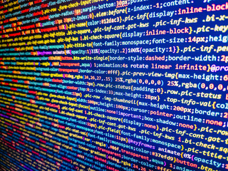 Computer code background. Colorful programming source typed on the screen of the monitor with shallow focus effect. Modern technology and futuristic concept abstract visualization of software. 
