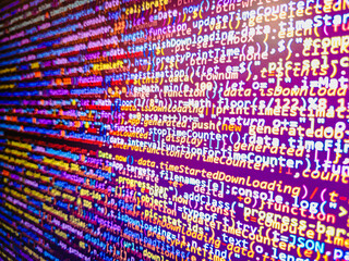 Computer code background. Colorful programming source typed on the screen of the monitor with shallow focus effect. Modern technology and futuristic concept abstract visualization of software. 
