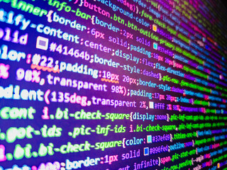 Script on computer with source code. Simple website HTML code with colourful tags in browser view on dark background. Digital computer code and black background