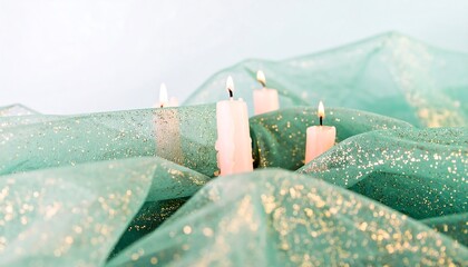 Soft pastel candles nestled in shimmering fabric