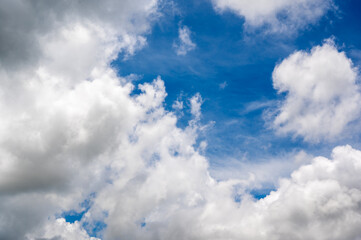 Blue Sky with Fluffy White Clouds in a Bright Daylight Scene