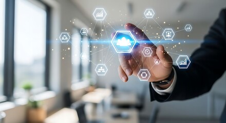 A person interacting with a digital interface featuring cloud and network icons in an office setting