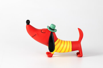 Brightly colored ceramic dog figurine on white background