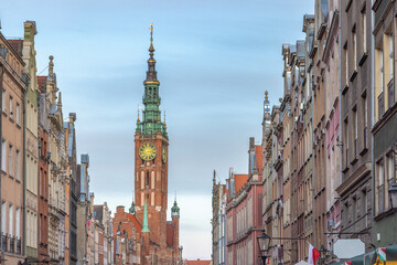 Gdansk, a city on Baltic coast of northern Poland, Europe. Historical European city street view, featuring a central clock tower and intricate architecture, conveying cultural richness and heritage.