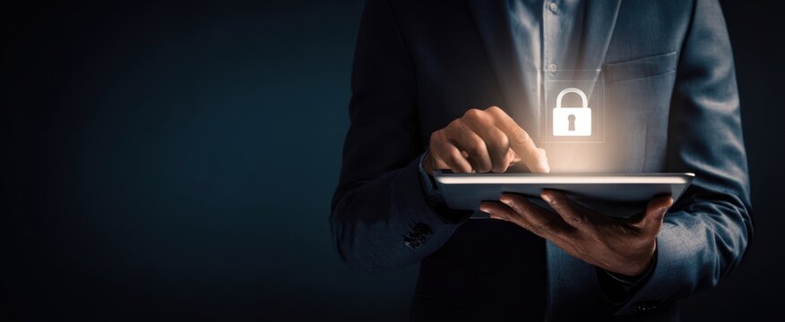 The businessman using a tablet to enhance digital security and privacy.