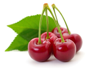 Fresh cherries with green leaves isolated on white background