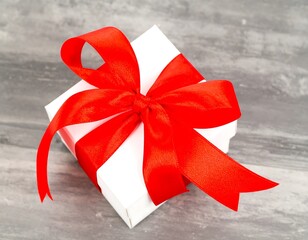 White gift box with red ribbon