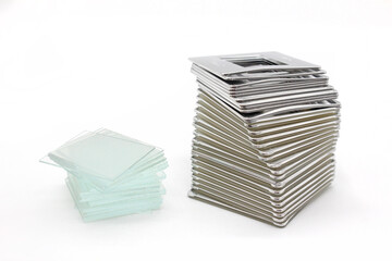 Slide plastic frames piled on a white background