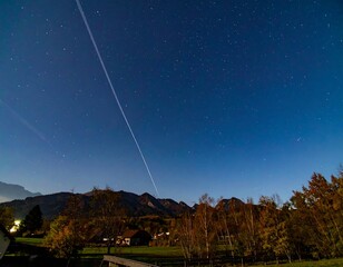Night sky with trails and mountains