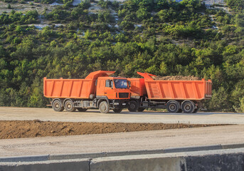 dump trucks at the construction of a road