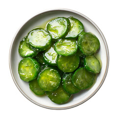 Marinated cucumber slices in a bowl overhead view
