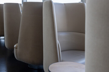Close-up of modern lounge chairs arranged in an airport waiting area.