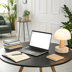 Fototapeta premium A gray laptop with a blank white screen sits on a black round table next to a stack of books and a mushroom-shaped lamp