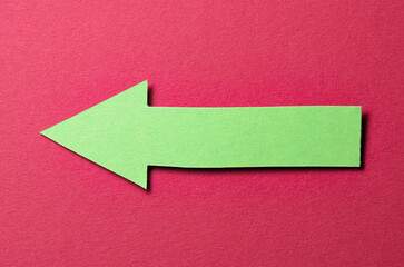 Green cut out blank paper cardboard arrow direction sign with copy space for text on red...
