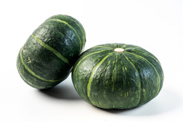 Whole green-skinned pumpkin on white background, autumn harvest