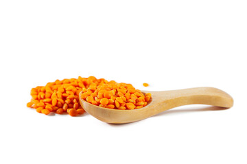 Heap of red lentils with wooden spoon isolated on white background.