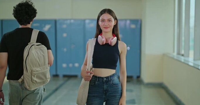 Indian young adult gen z woman lady wear bag proud fold hand look camera ready for exam enjoy new day time Happy teen girl female cross arm staring cam do casual pose people walk around indoor place